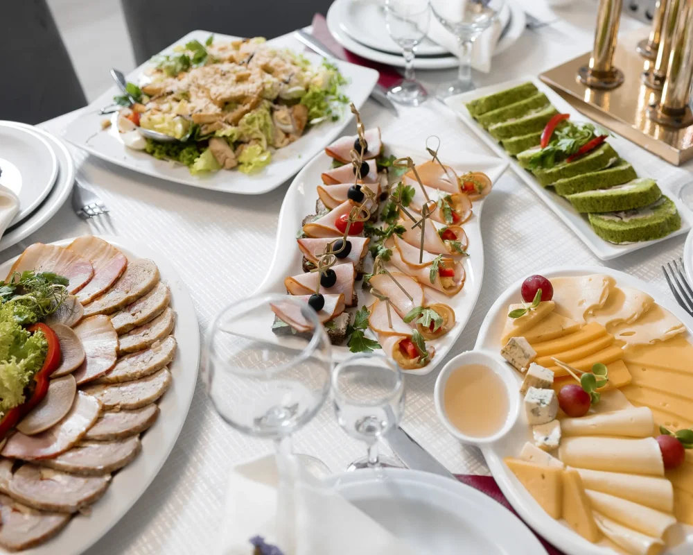 table-with-variety-food-including-large-plate-meat-salad